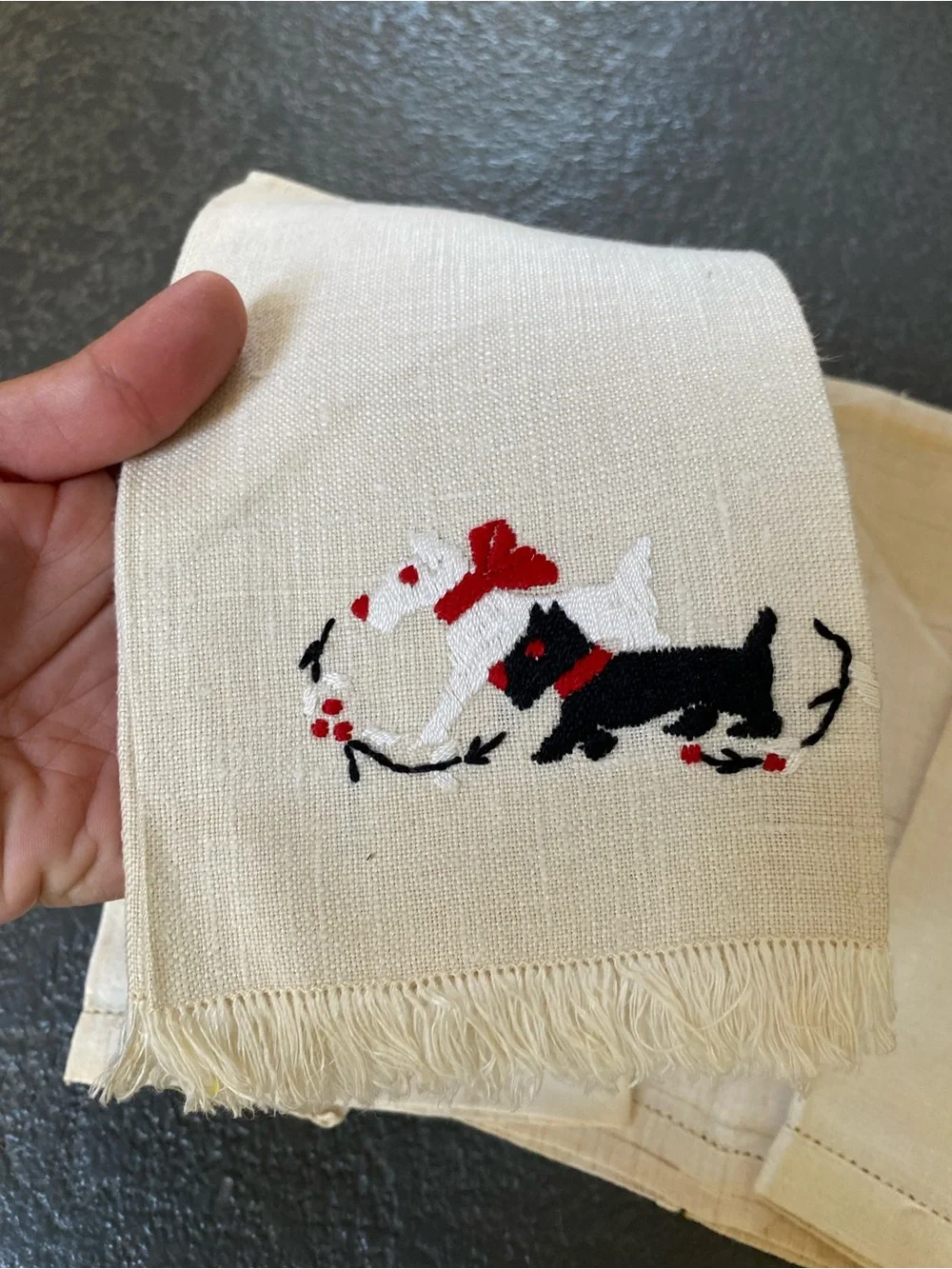 The image shows a set of four vintage hand-embroidered and cross-stitched